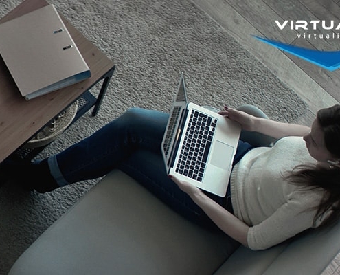 birds-eye view of woman sitting on couch holding a laptop