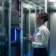 Image of a person using a tablet inside of a data center.